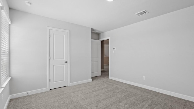 unfurnished bedroom featuring light colored carpet