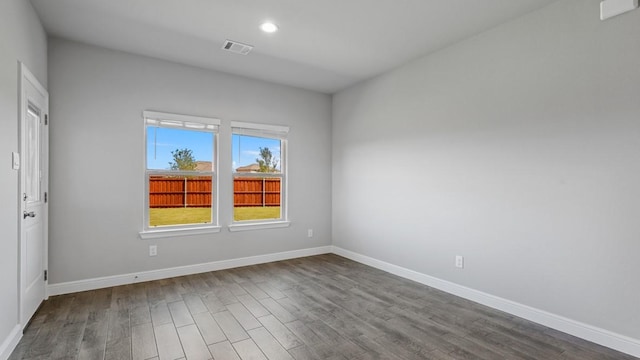 spare room featuring wood-type flooring