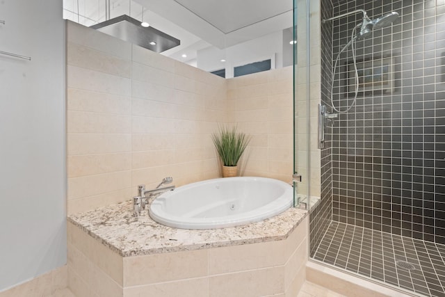 bathroom featuring separate shower and tub