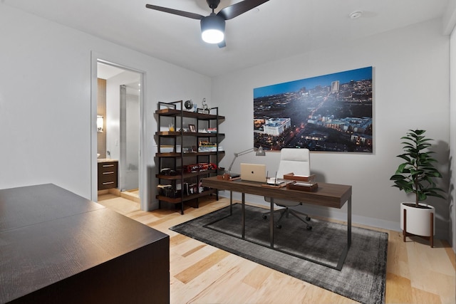 office with ceiling fan and light hardwood / wood-style floors