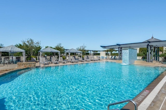 view of swimming pool featuring a gazebo and pool water feature