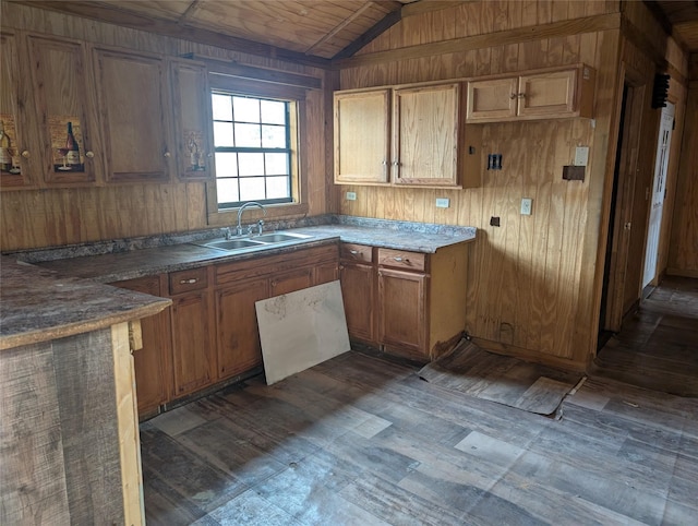 kitchen with vaulted ceiling, wood walls, sink, dark wood-type flooring, and wooden ceiling