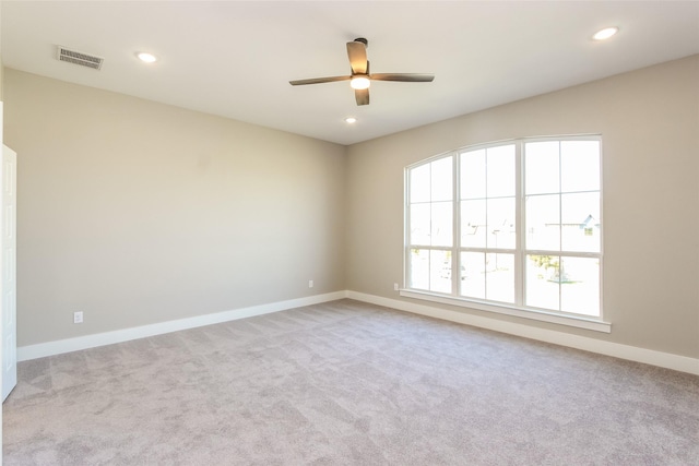 carpeted empty room featuring ceiling fan