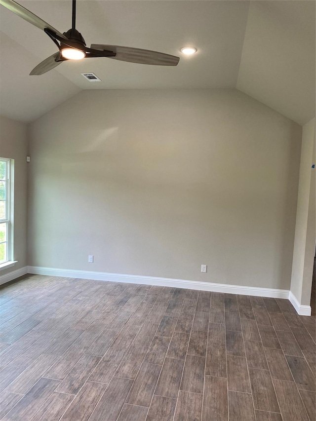 spare room with dark wood-type flooring, ceiling fan, and lofted ceiling