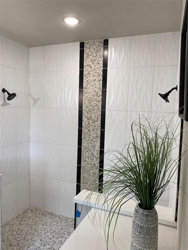 bathroom with a tile shower