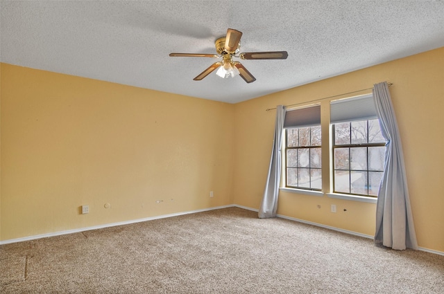 unfurnished room featuring ceiling fan, carpet, and a textured ceiling