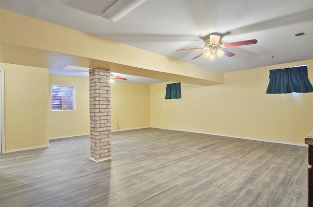 basement featuring ceiling fan and hardwood / wood-style floors