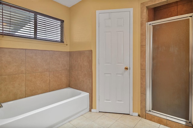 bathroom featuring tile patterned floors and independent shower and bath