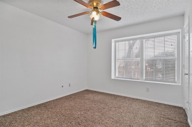 carpeted spare room with ceiling fan and a textured ceiling