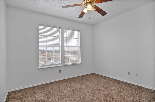 carpeted empty room with ceiling fan and a textured ceiling