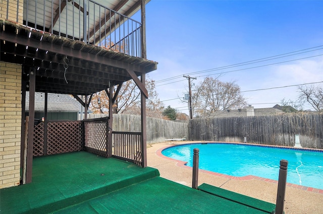 view of pool featuring a diving board