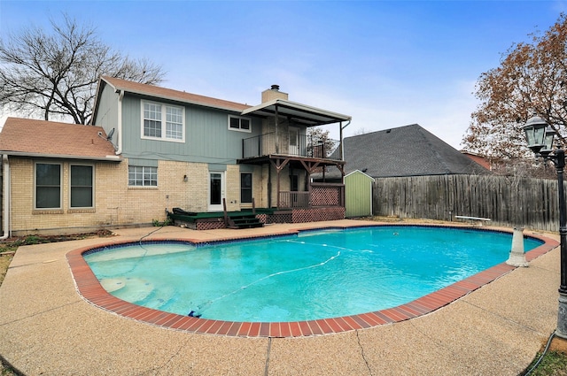 view of pool featuring a diving board