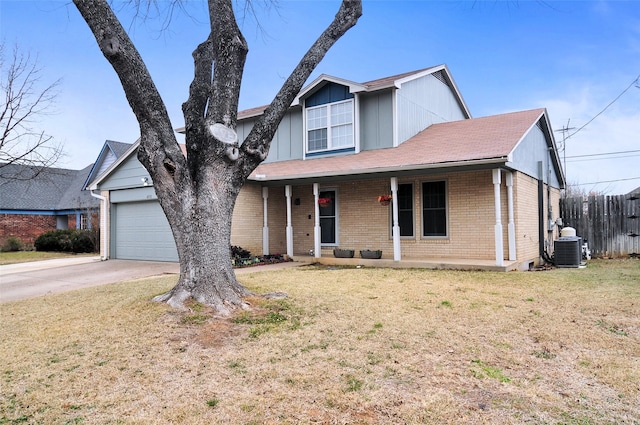 view of front facade featuring a garage, central AC unit, covered porch, and a front yard