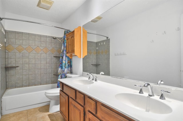 full bathroom with vanity, shower / tub combo, toilet, tile patterned floors, and a textured ceiling