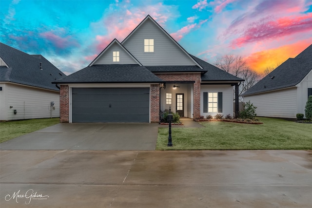 view of front of house with a garage and a lawn