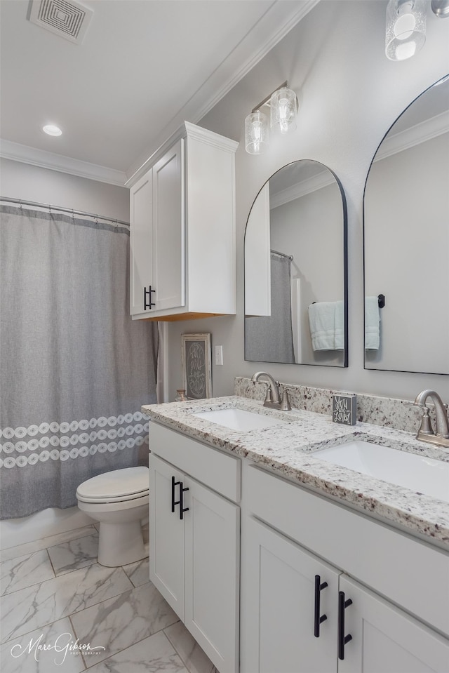 bathroom with ornamental molding, toilet, and vanity