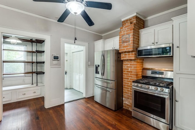 kitchen featuring appliances with stainless steel finishes, dark hardwood / wood-style floors, white cabinetry, ornamental molding, and ceiling fan