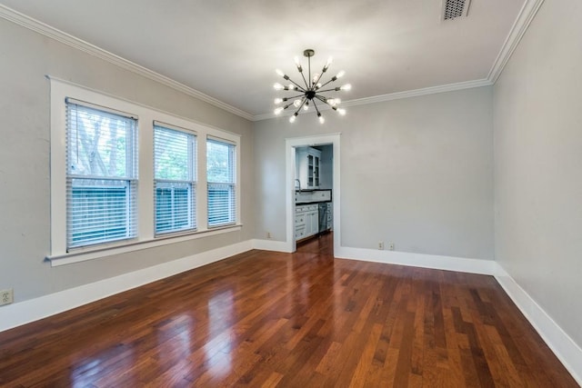 empty room featuring ornamental molding, dark hardwood / wood-style floors, and a chandelier