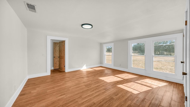 empty room with light hardwood / wood-style flooring