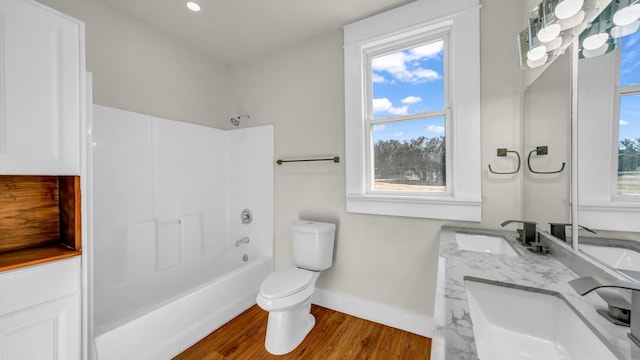 full bathroom with shower / washtub combination, toilet, hardwood / wood-style floors, and vanity