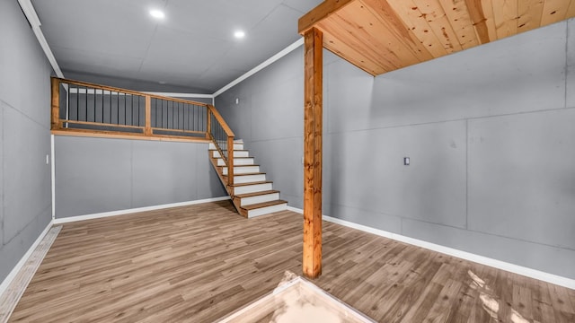 stairway featuring hardwood / wood-style floors and ornamental molding