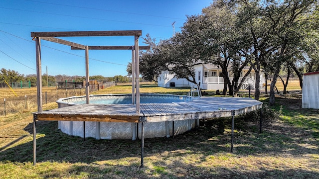 view of swimming pool with a lawn