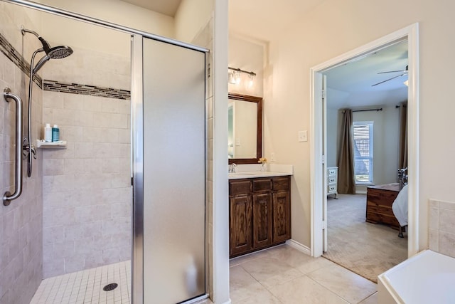 bathroom with ceiling fan, tile patterned floors, vanity, and a shower with door