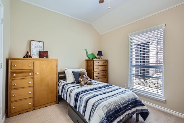 bedroom featuring ornamental molding, lofted ceiling, light carpet, and ceiling fan