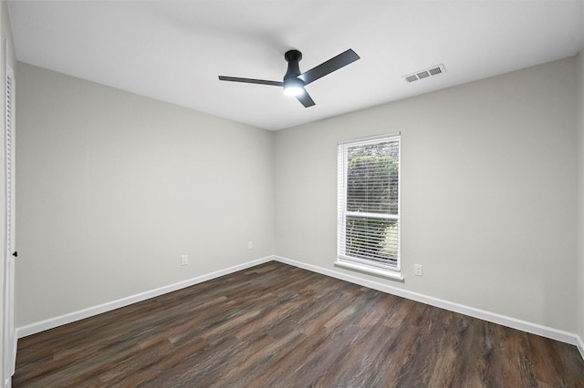 empty room with dark wood-type flooring and ceiling fan