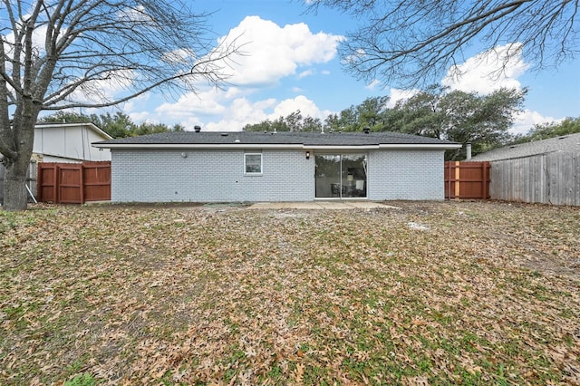 rear view of house with a yard and a patio