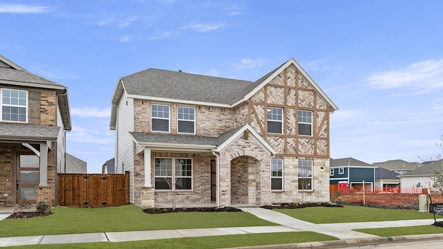 english style home featuring a front yard