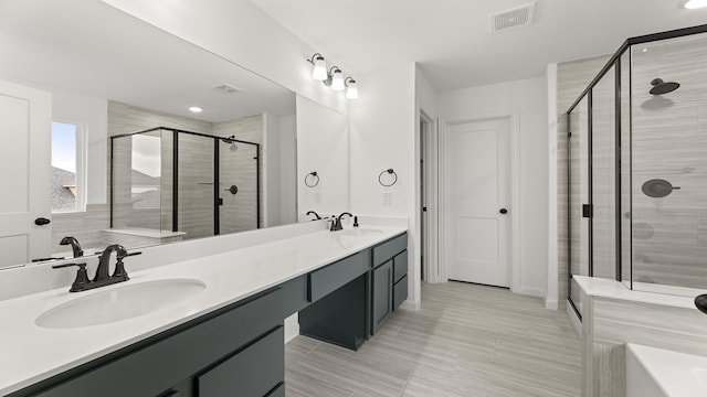 bathroom featuring vanity and a shower with shower door