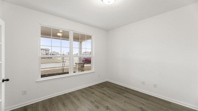 empty room with dark hardwood / wood-style flooring