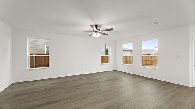 spare room featuring dark hardwood / wood-style floors and ceiling fan