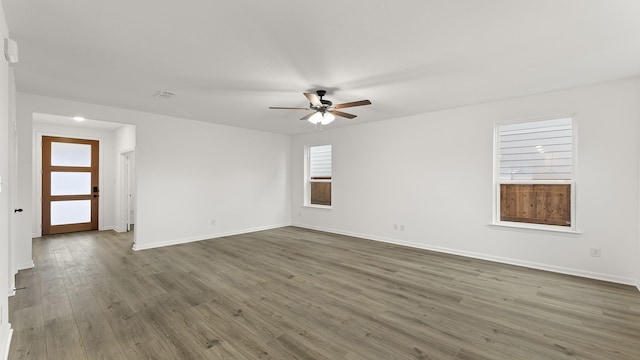 spare room featuring ceiling fan and dark hardwood / wood-style floors