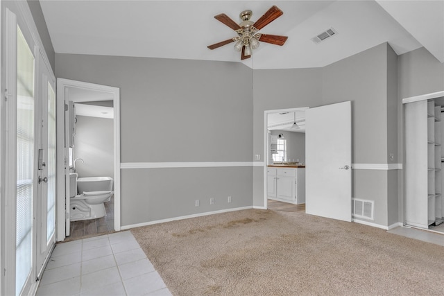 unfurnished bedroom featuring carpet, visible vents, and ensuite bath