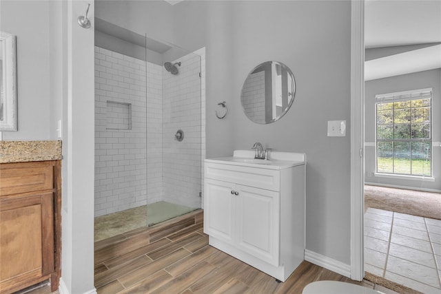 bathroom with a shower stall, vanity, and wood tiled floor