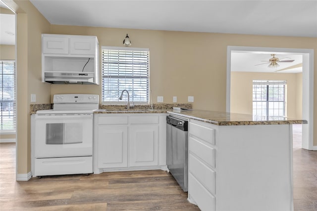 kitchen with white electric range oven, a sink, a peninsula, dishwasher, and under cabinet range hood