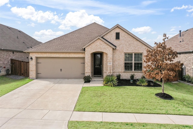 view of front of home featuring a garage and a front yard