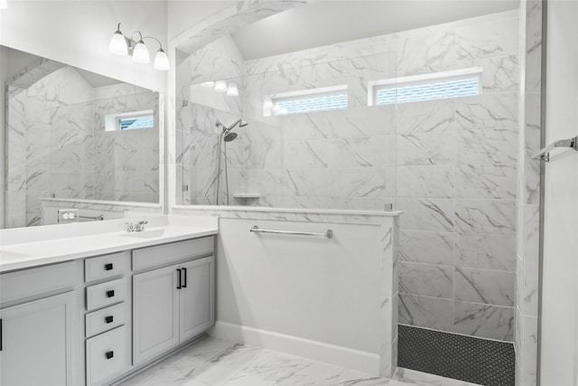 bathroom with vanity and tiled shower