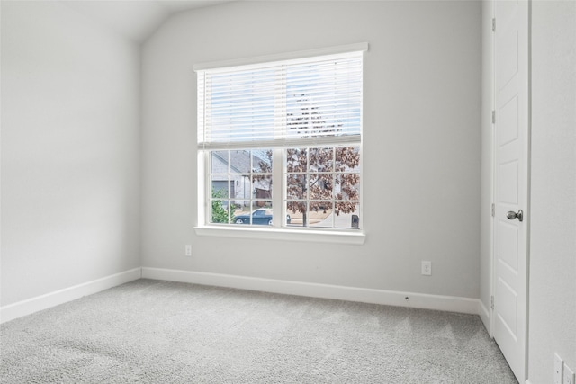 carpeted spare room featuring baseboards