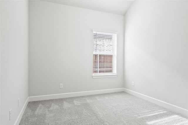 unfurnished room featuring carpet floors and baseboards