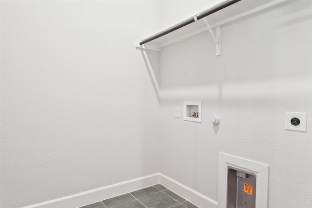 clothes washing area with hookup for a washing machine, gas dryer hookup, electric dryer hookup, dark tile patterned flooring, and laundry area