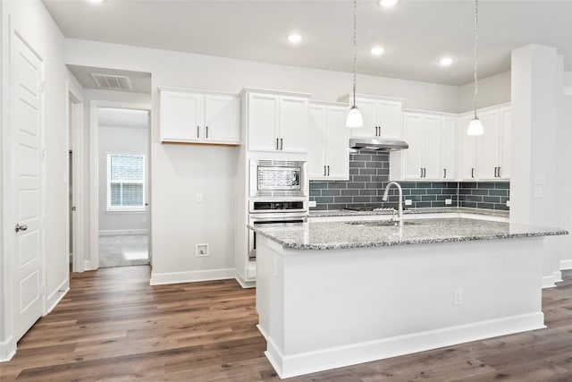 kitchen featuring white cabinetry, appliances with stainless steel finishes, sink, and light stone counters