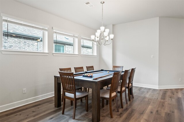 dining area with dark wood-type flooring and a chandelier