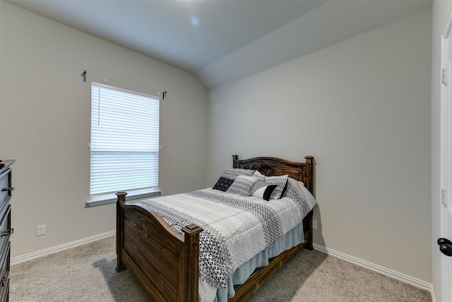 bedroom featuring lofted ceiling, carpet floors, and baseboards