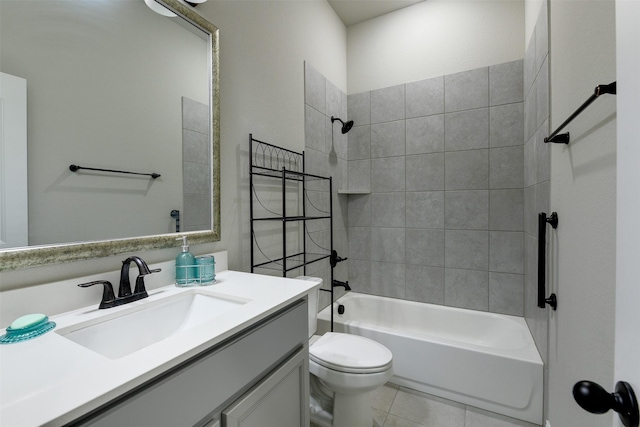 full bathroom featuring vanity, toilet, tiled shower / bath combo, and tile patterned flooring