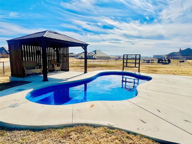 view of swimming pool with a fenced in pool, a patio area, fence, and a gazebo