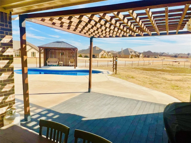 view of patio / terrace featuring a fenced in pool, a gazebo, fence, a pergola, and a residential view