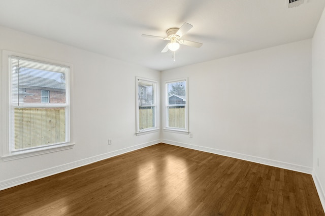 empty room featuring dark wood-type flooring and ceiling fan